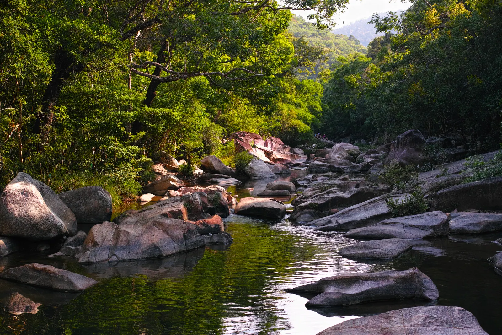 The Ba Ho stream tumbling between granite boulders into a clear pool