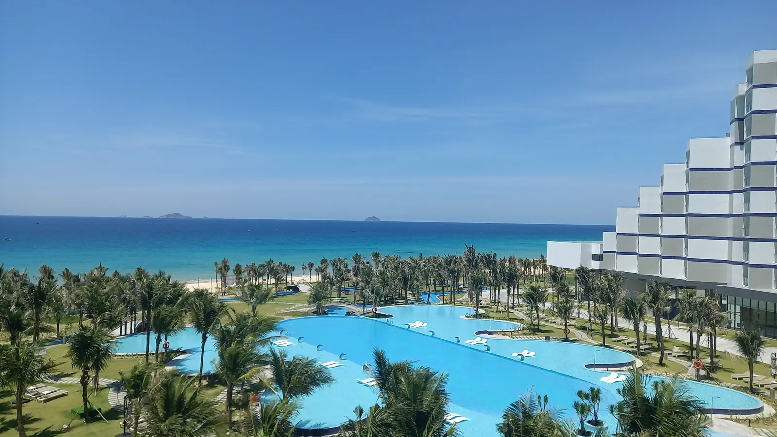 Clear water along the Cam Ranh shoreline under an open sky