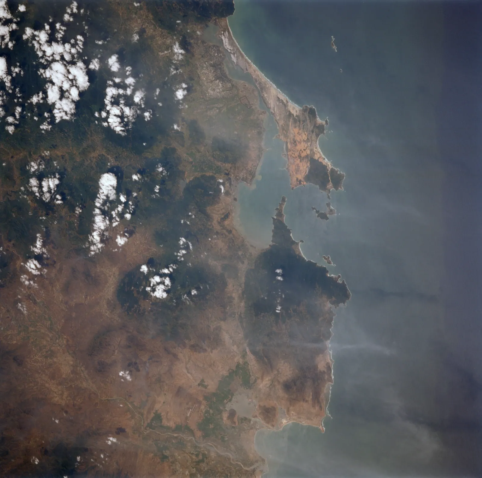 Satellite view of Cam Ranh Bay: the long peninsula, the deep-water inlet and the islands at the mouth of the bay