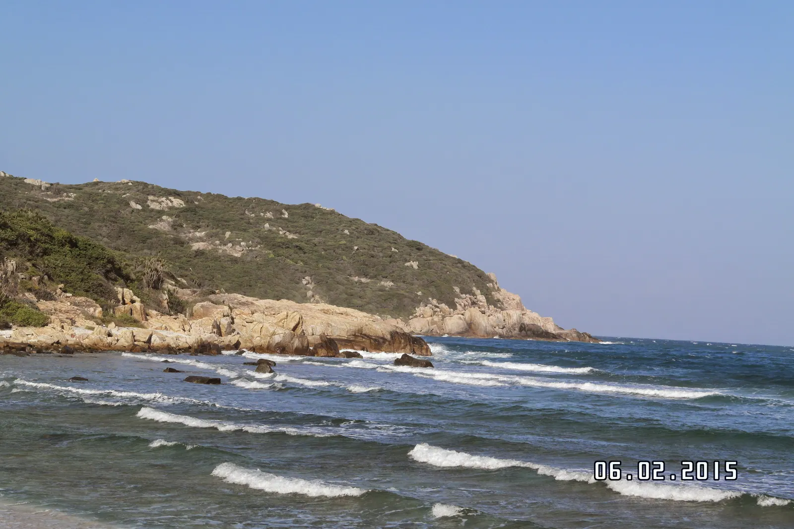 The DT702 coast road winding along the cliffs between Phan Rang and Cam Ranh, with the sea below