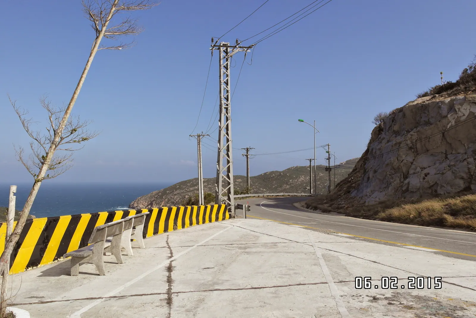 The coastal road between Phan Rang and Cam Ranh curving along the shore below dry hills