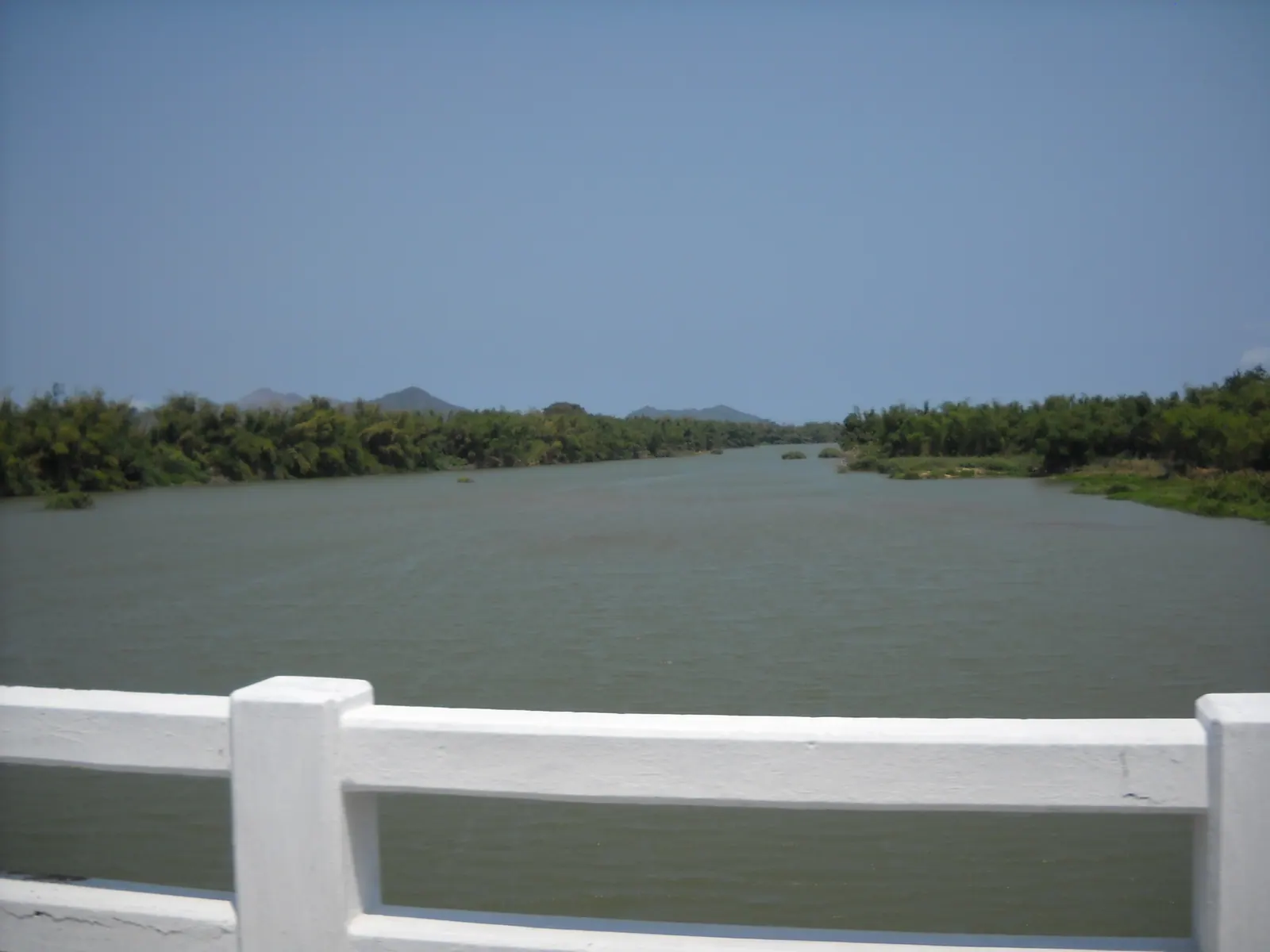 The wide, tree-lined Cai river upstream at Dien Khanh